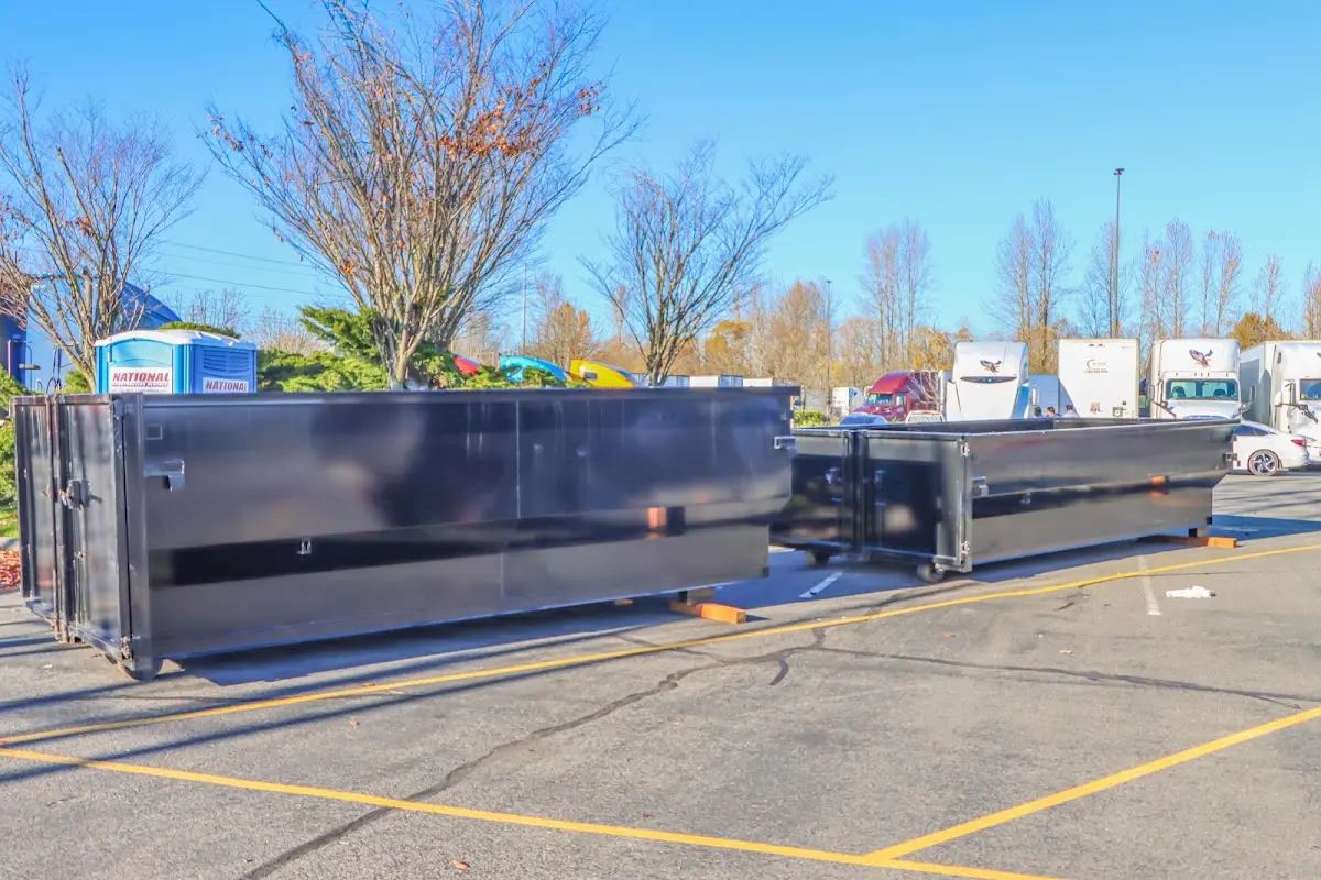 Professional dumpster rental service with roll-off container on residential driveway in Tanglewilde